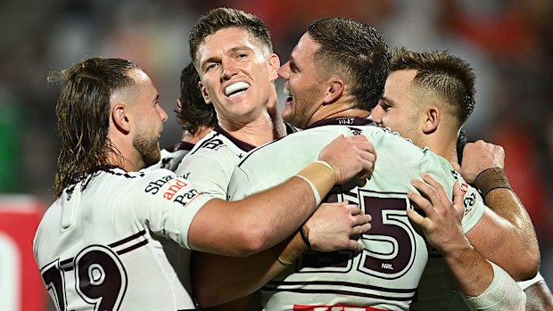 Corey Waddell celebrates with teammates after scoring a try.