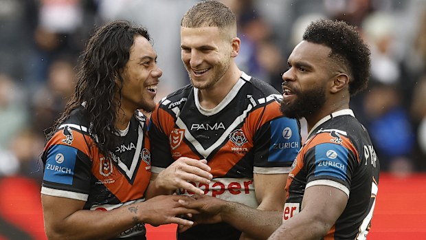 SYDNEY, AUSTRALIA - AUGUST 03: Jarome Luai, Adam Doueihi and Sunia Turuva of the Wests Tigers celebrate victory during the round 22 NRL match between Wests Tigers and Canterbury Bulldogs at CommBank Stadium, on August 03, 2025, in Sydney, Australia. (Photo by Mark Evans/Getty Images)