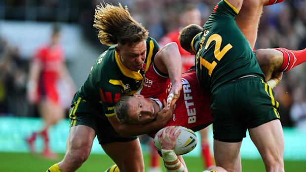 Mikolaj Oledzki of England is tackled by Reuben Cotter and Hudson Young during the Ashes series.