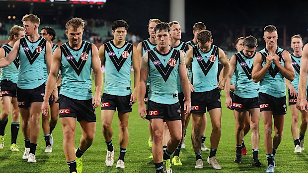 Zak Butters leads the team off after the loss.