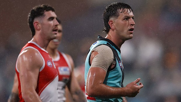 Zak Butters of the Power is seen after giving away a 50 metre penalty.